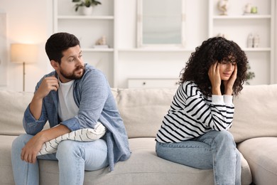 Couple having quarrel on sofa at home. Relationship problems