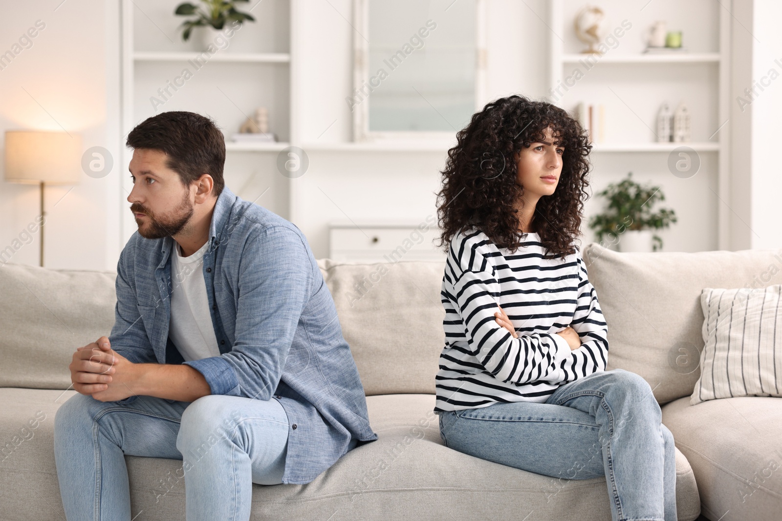 Photo of Couple having quarrel on sofa at home. Relationship problems