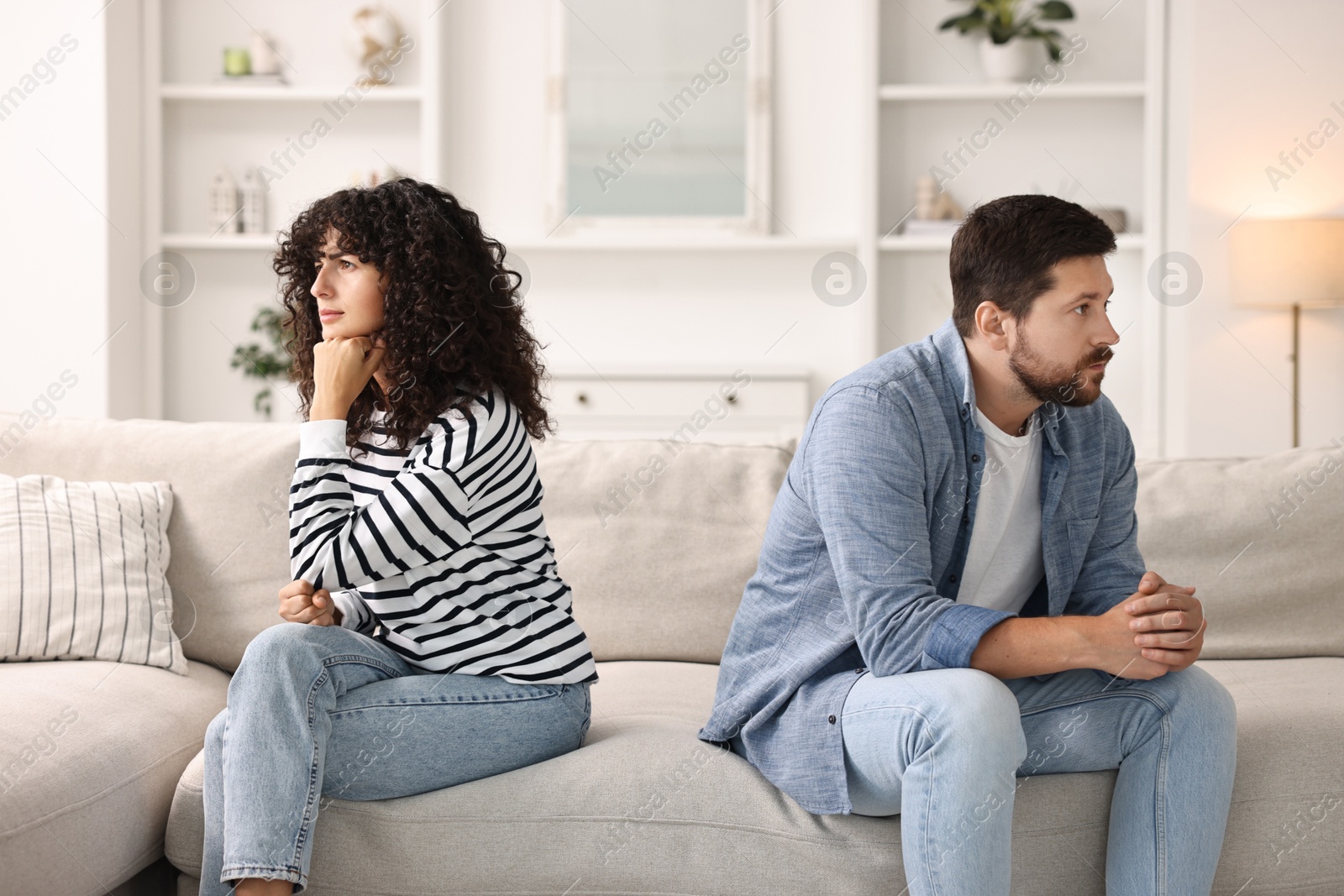 Photo of Couple having quarrel on sofa at home. Relationship problems