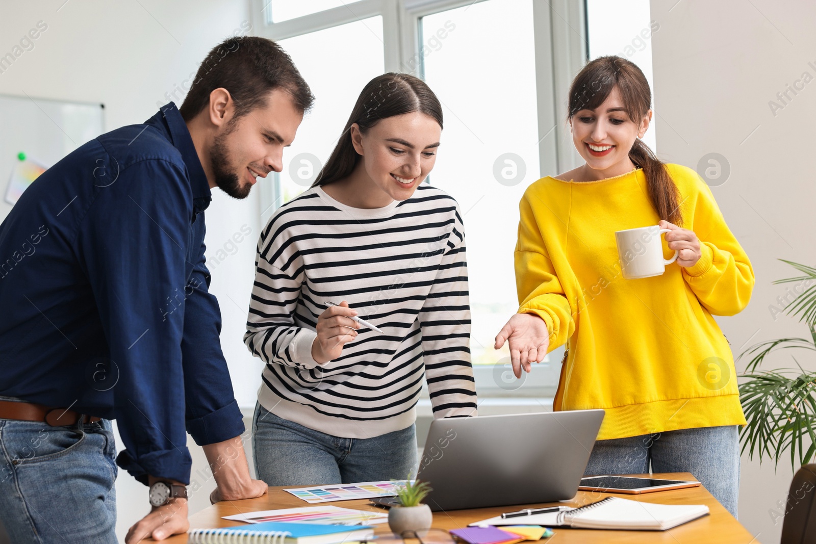 Photo of Group of designers working together in office