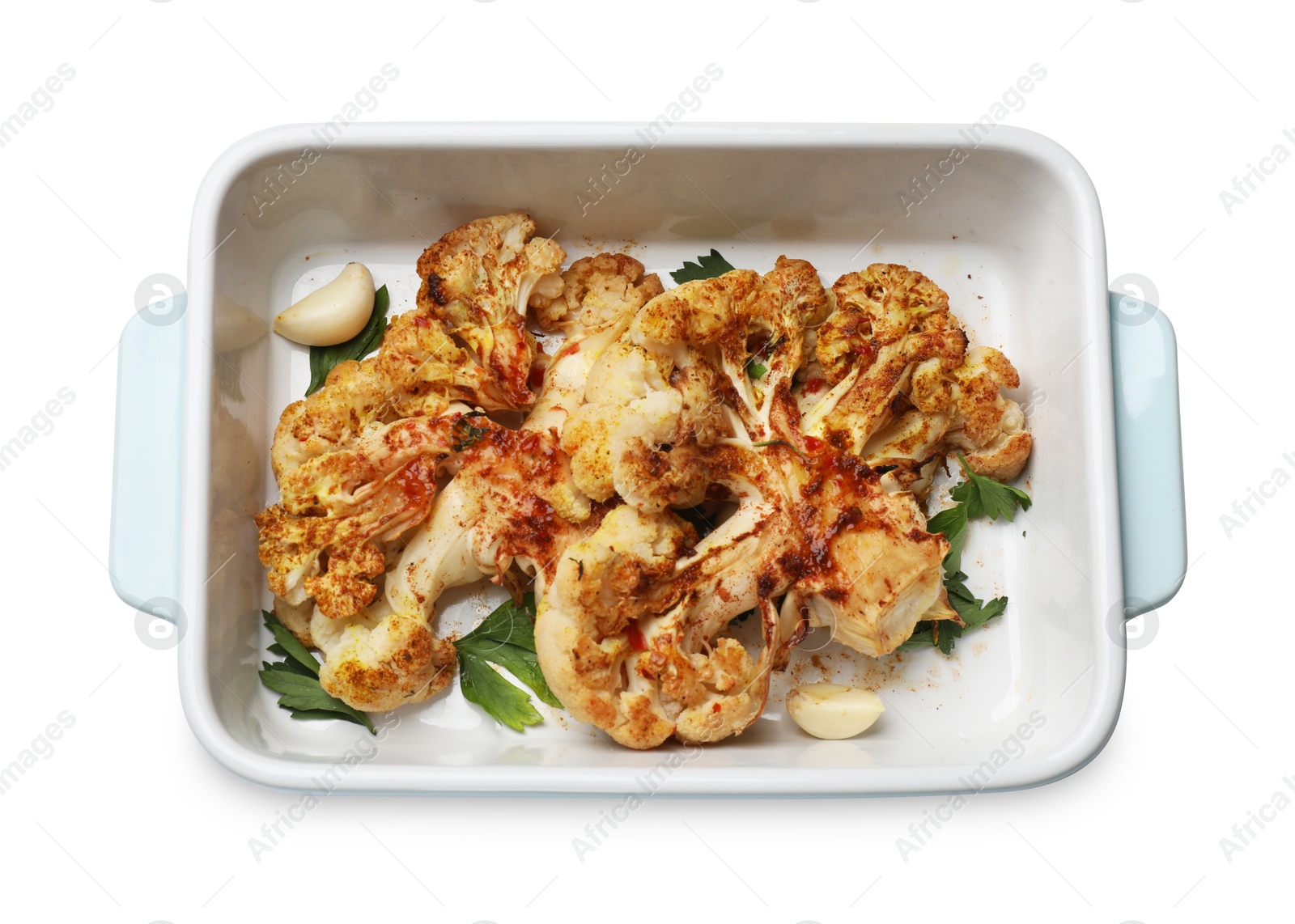 Photo of Delicious baked cauliflower steaks with garlic and parsley in baking dish isolated on white, top view