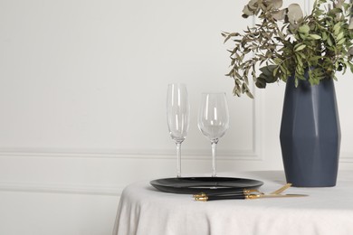 Photo of Stylish table setting with black dishware in dining room, space for text