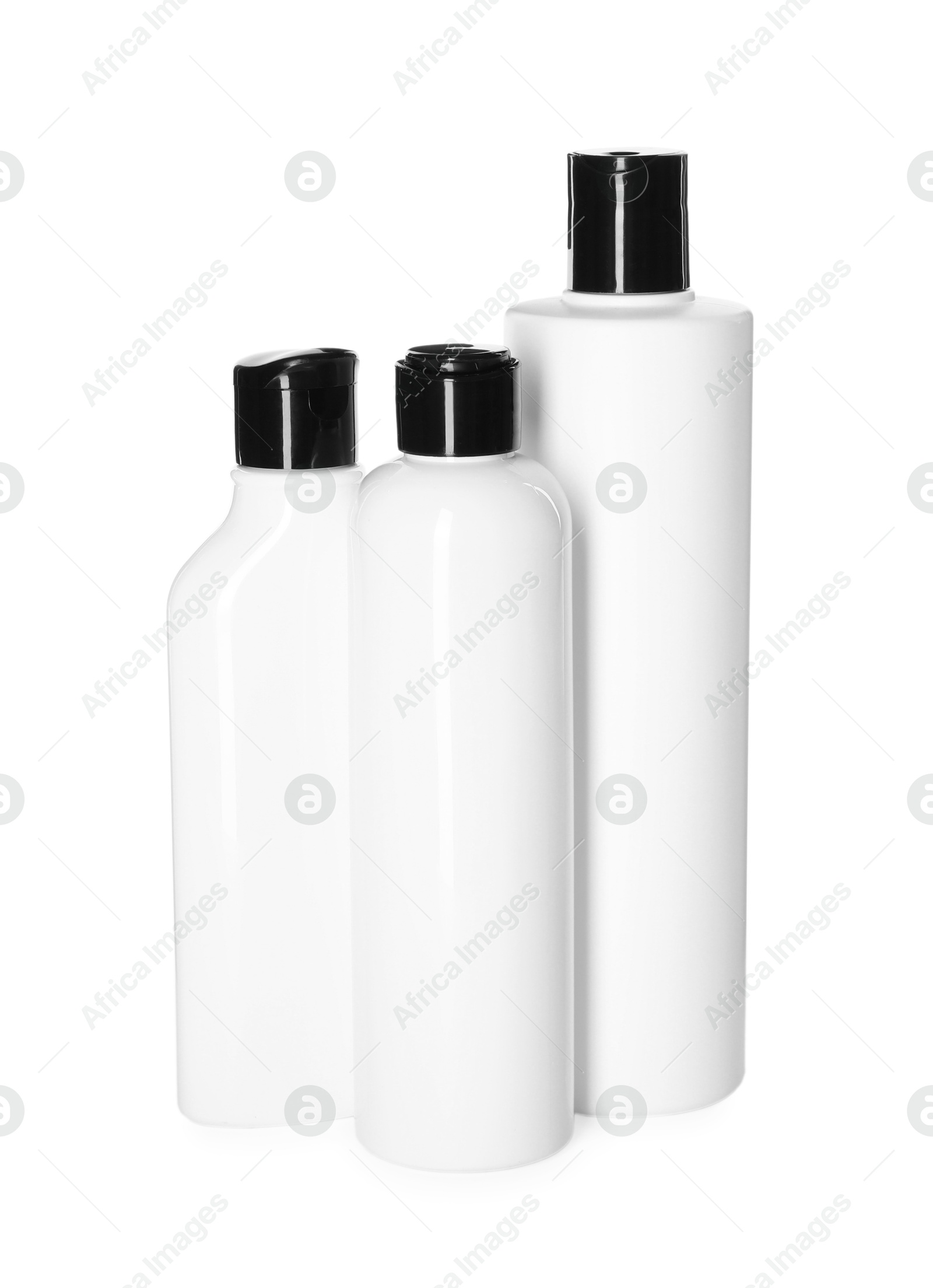 Photo of Bottles of shampoo isolated on white. Personal care product