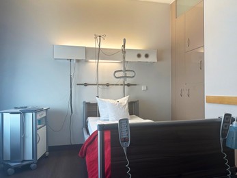 Photo of Modern interior of hospital ward with bed