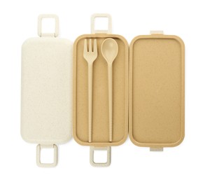 Photo of Compartments of plastic lunch box with cutlery isolated on white, top view