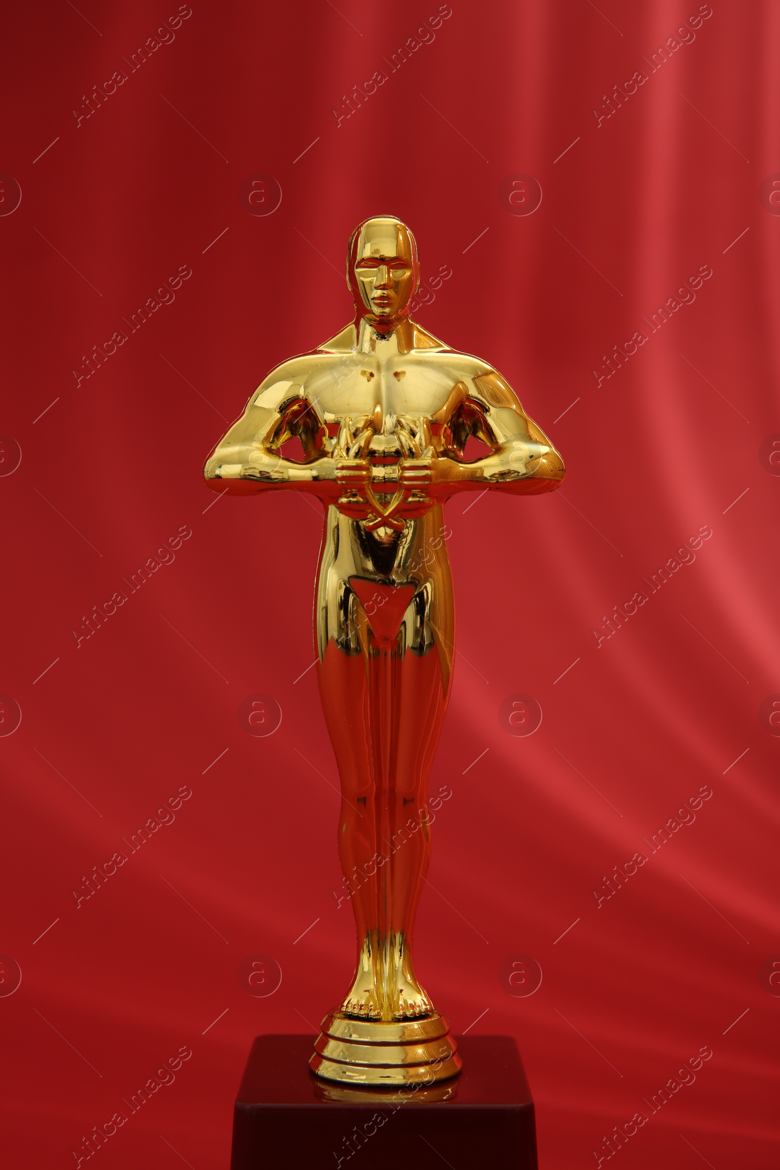 Photo of One golden Oscar award on red background