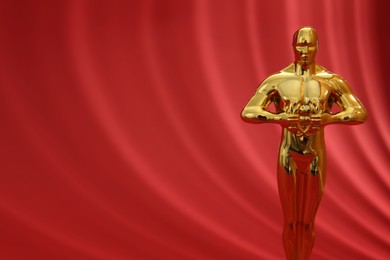 One golden Oscar award on red background, space for text