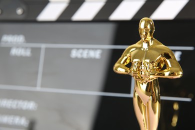 Golden Oscar award on blurred background, closeup. Space for text