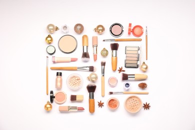 Photo of Different makeup brushes, decorative cosmetics and Christmas decor on white background, flat lay