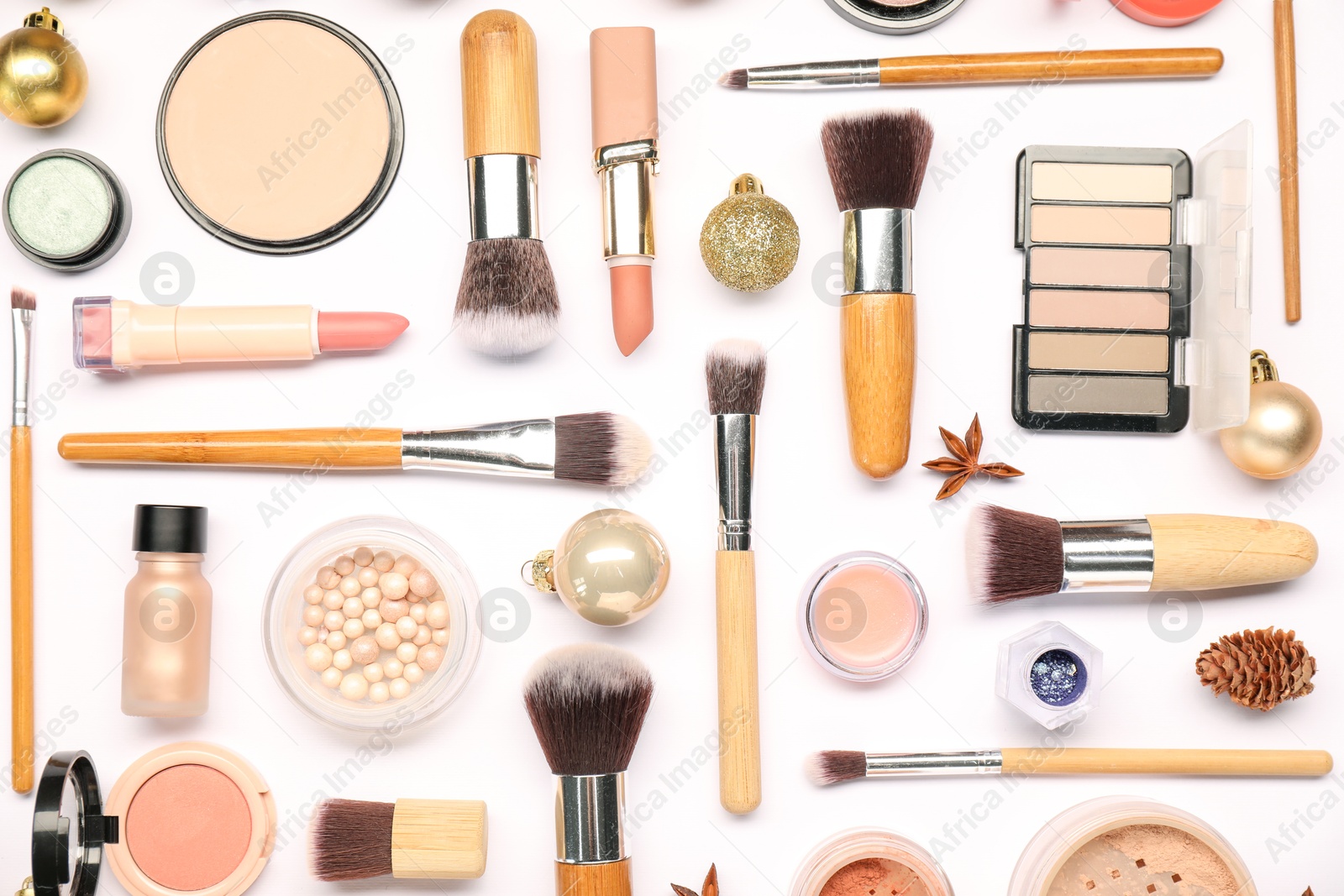 Photo of Different makeup brushes, decorative cosmetics and Christmas decor on white background, flat lay