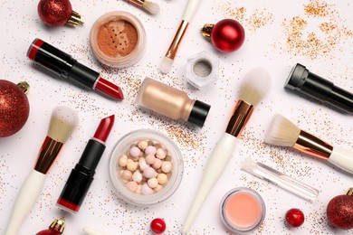 Photo of Different makeup brushes, decorative cosmetics and Christmas decor on white background, flat lay