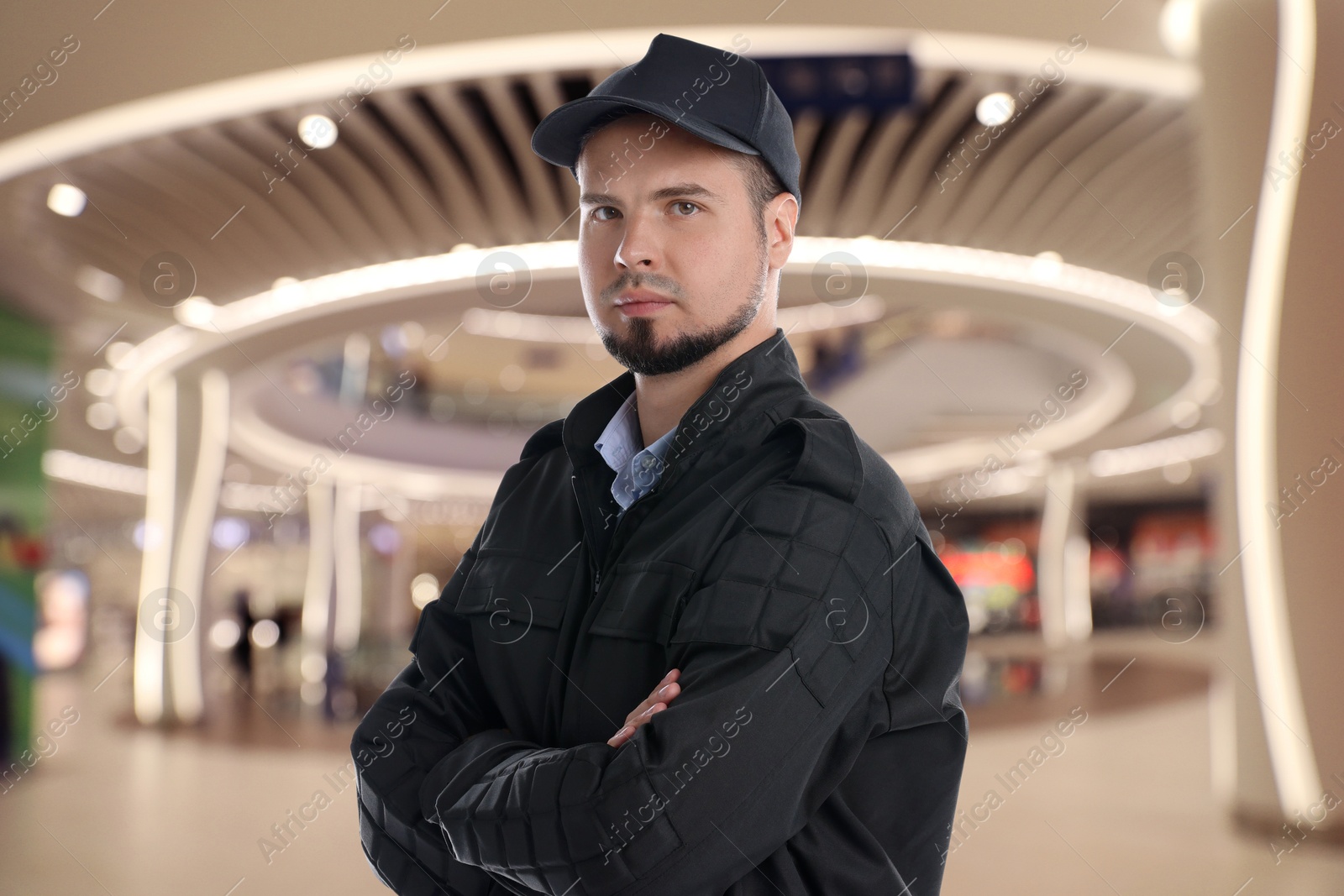 Image of Portrait of confident security guard in shopping mall