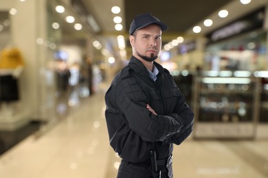 Image of Portrait of confident security guard in shopping mall