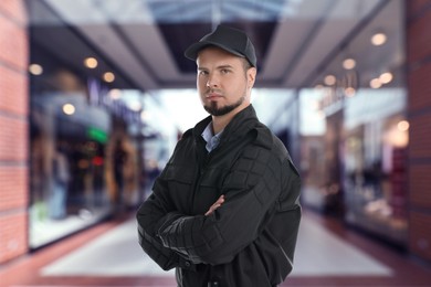 Image of Portrait of confident security guard in shopping mall