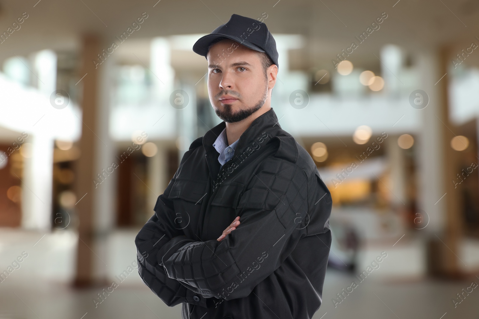 Image of Portrait of confident security guard in shopping mall