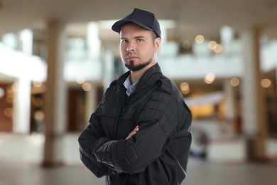 Portrait of confident security guard in shopping mall