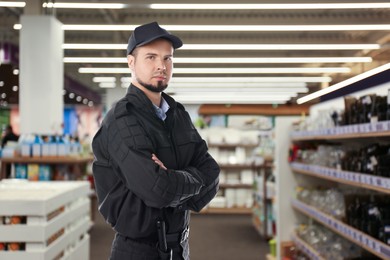 Confident security guard wearing uniform in supermarket