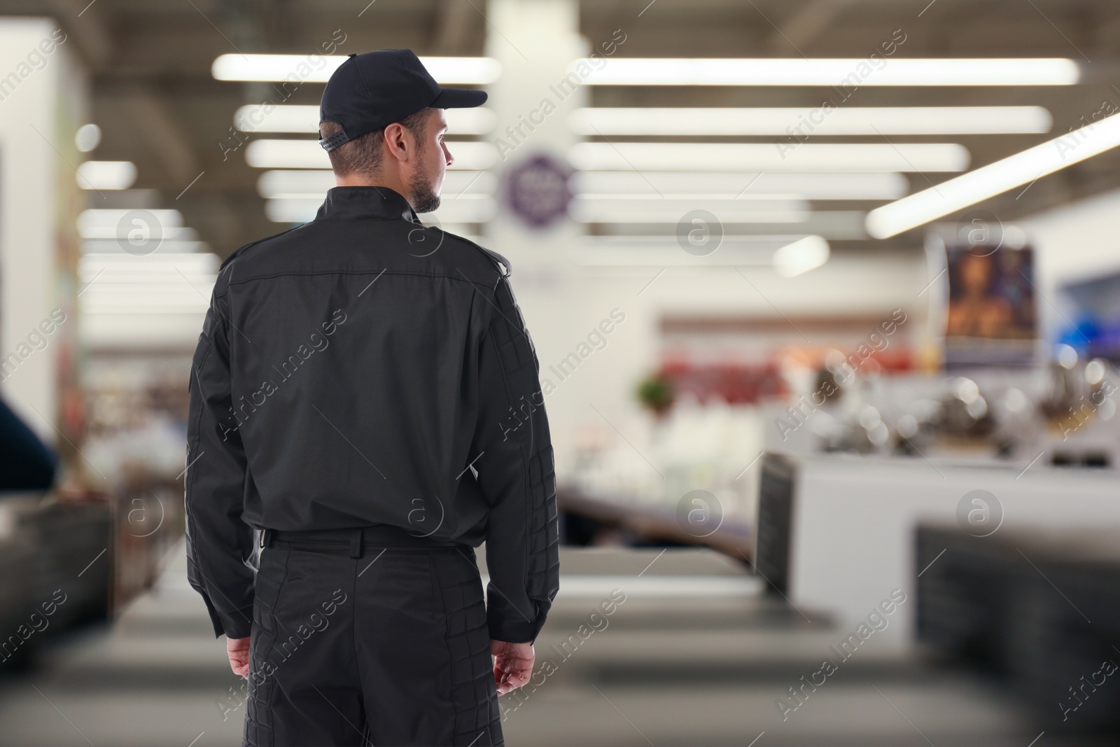 Image of Security guard in supermarket, back view. Space for text