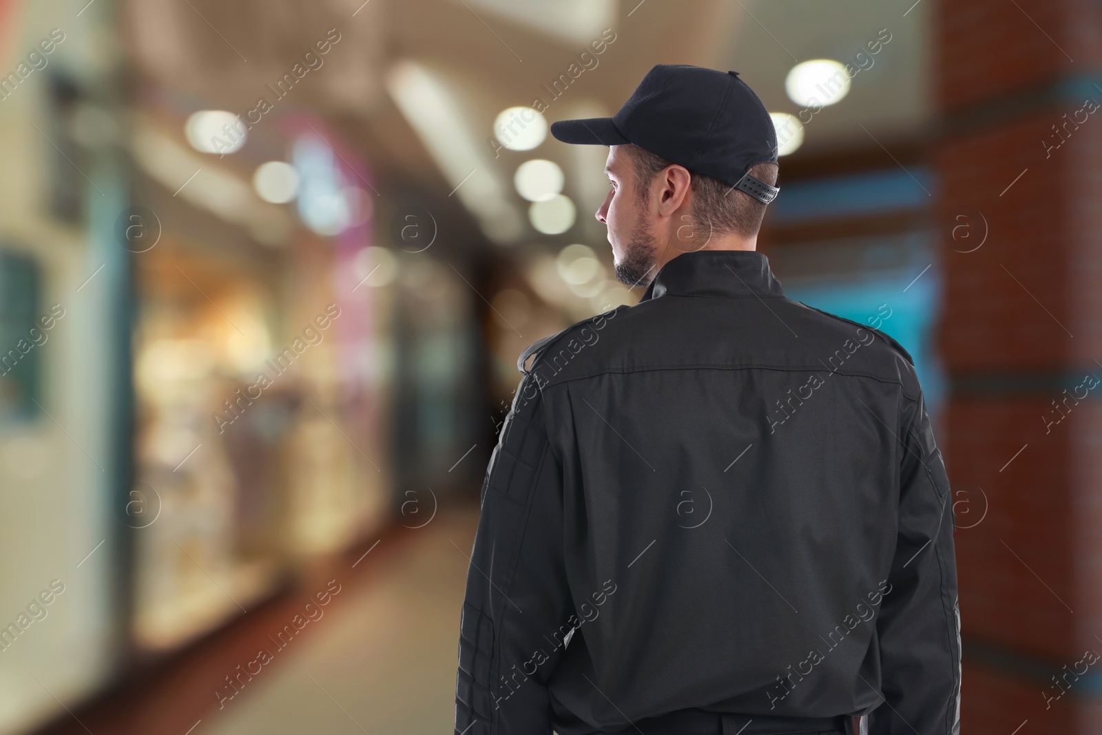 Image of Security guard in shopping mall, back view. Space for text