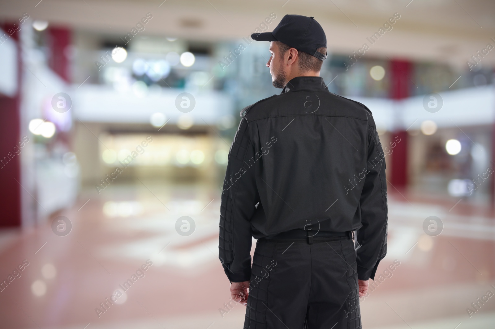 Image of Security guard in shopping mall, back view. Space for text