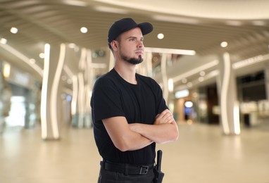 Portrait of confident security guard in shopping mall