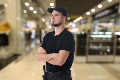 Image of Portrait of confident security guard in shopping mall