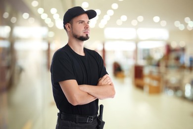 Image of Portrait of serious security guard in shopping mall. Space for text