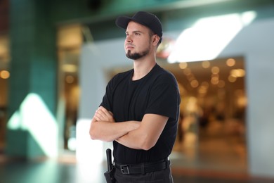 Image of Portrait of confident security guard in shopping mall