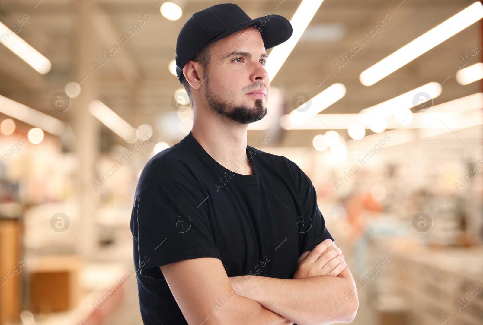 Image of Portrait of confident security guard in shopping mall