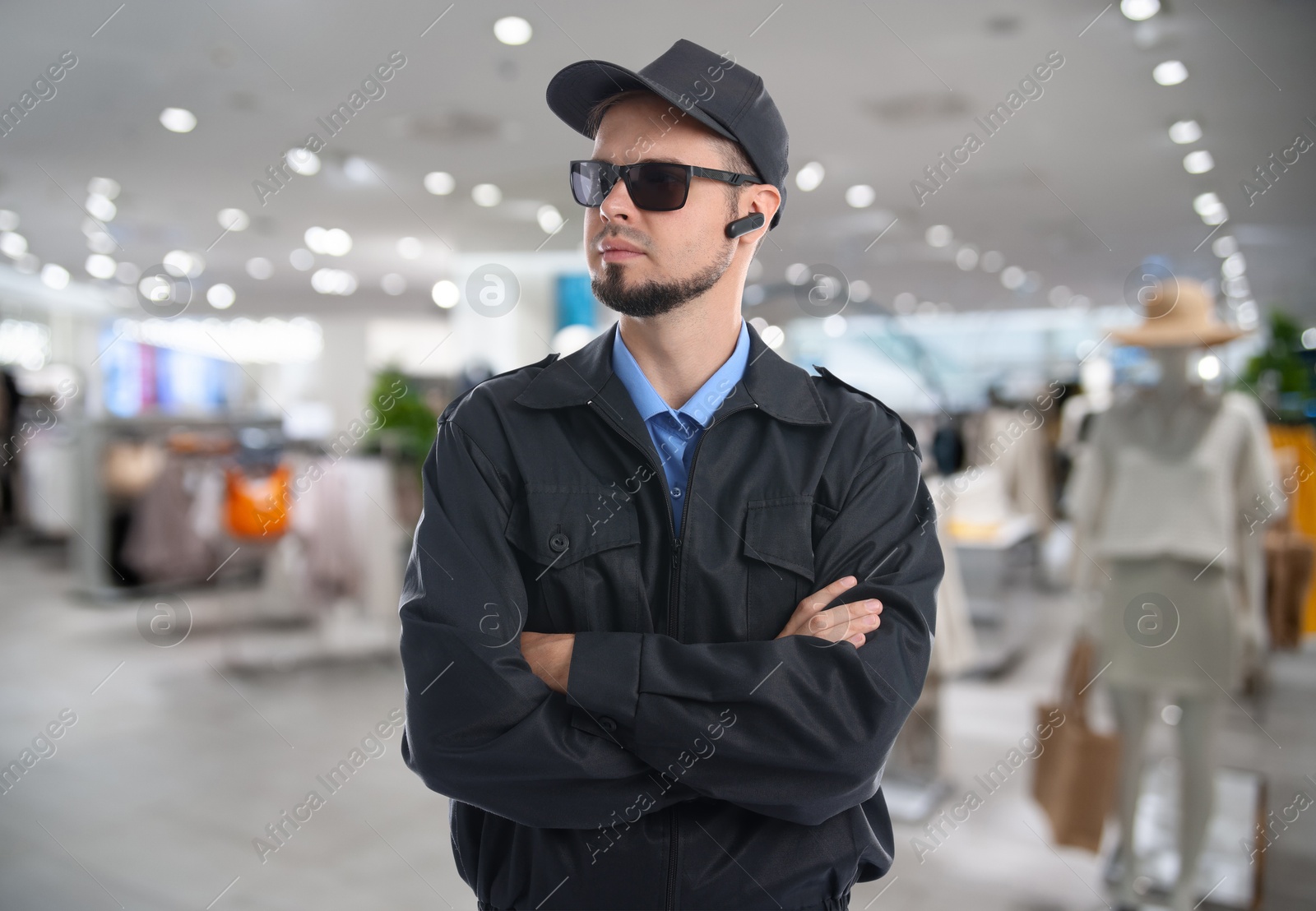 Image of Confident security guard with earpiece in clothing store