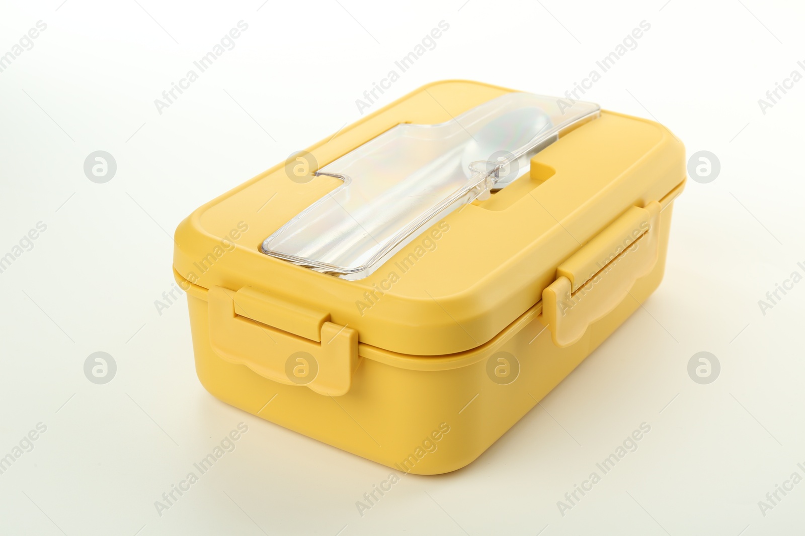 Photo of Yellow lunch box with cutlery isolated on white