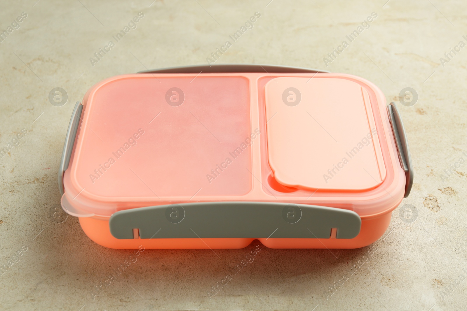 Photo of One plastic lunch box on grey table, closeup