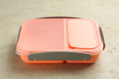 Photo of One plastic lunch box on grey table, closeup