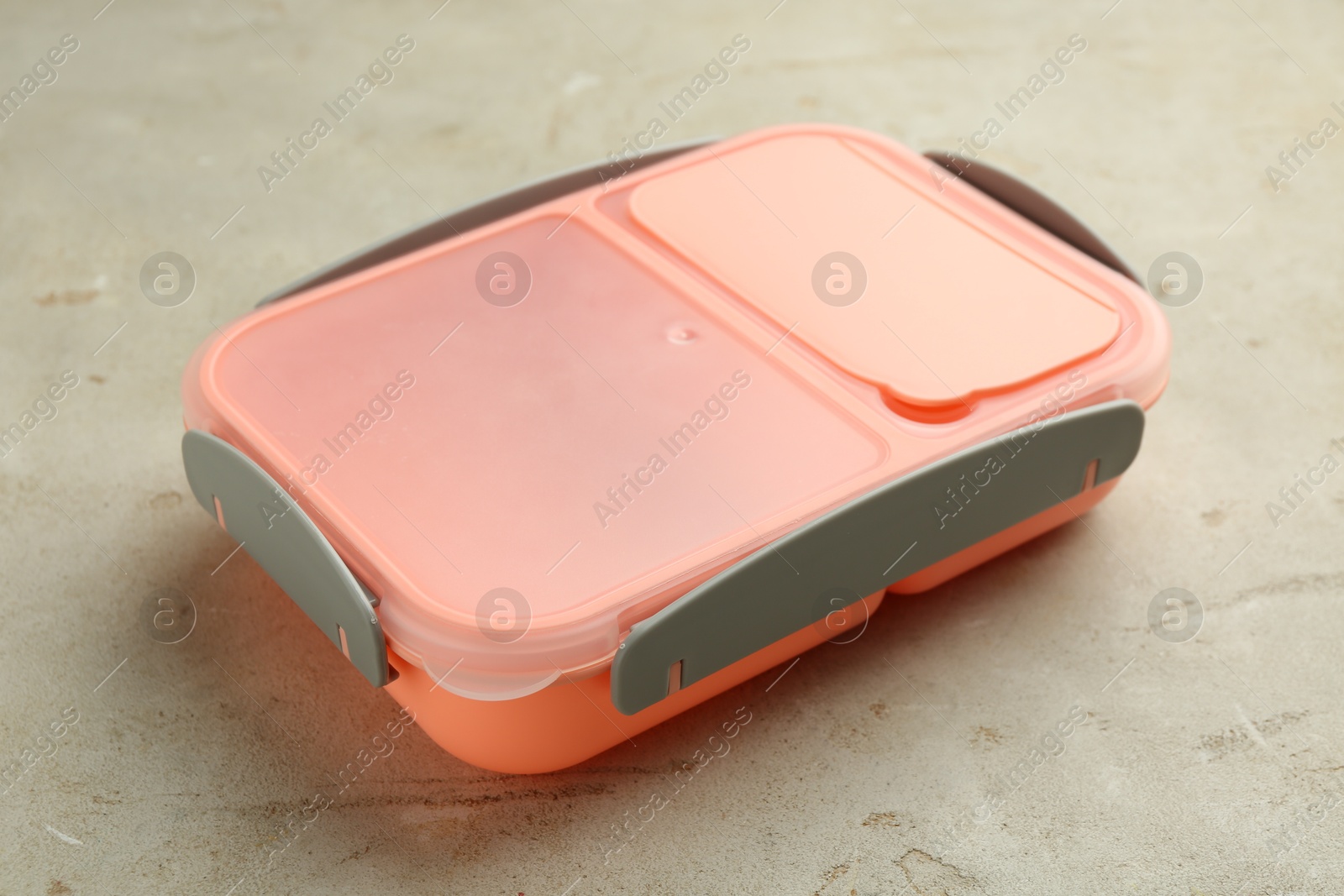 Photo of One plastic lunch box on grey table, closeup