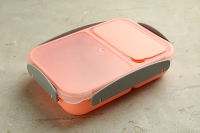 Photo of One plastic lunch box on grey table, closeup