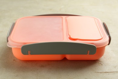 One plastic lunch box on grey table, closeup