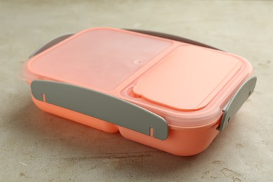 Photo of One plastic lunch box on grey table, closeup