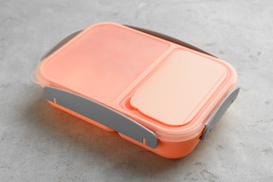 Photo of One plastic lunch box on grey table, closeup