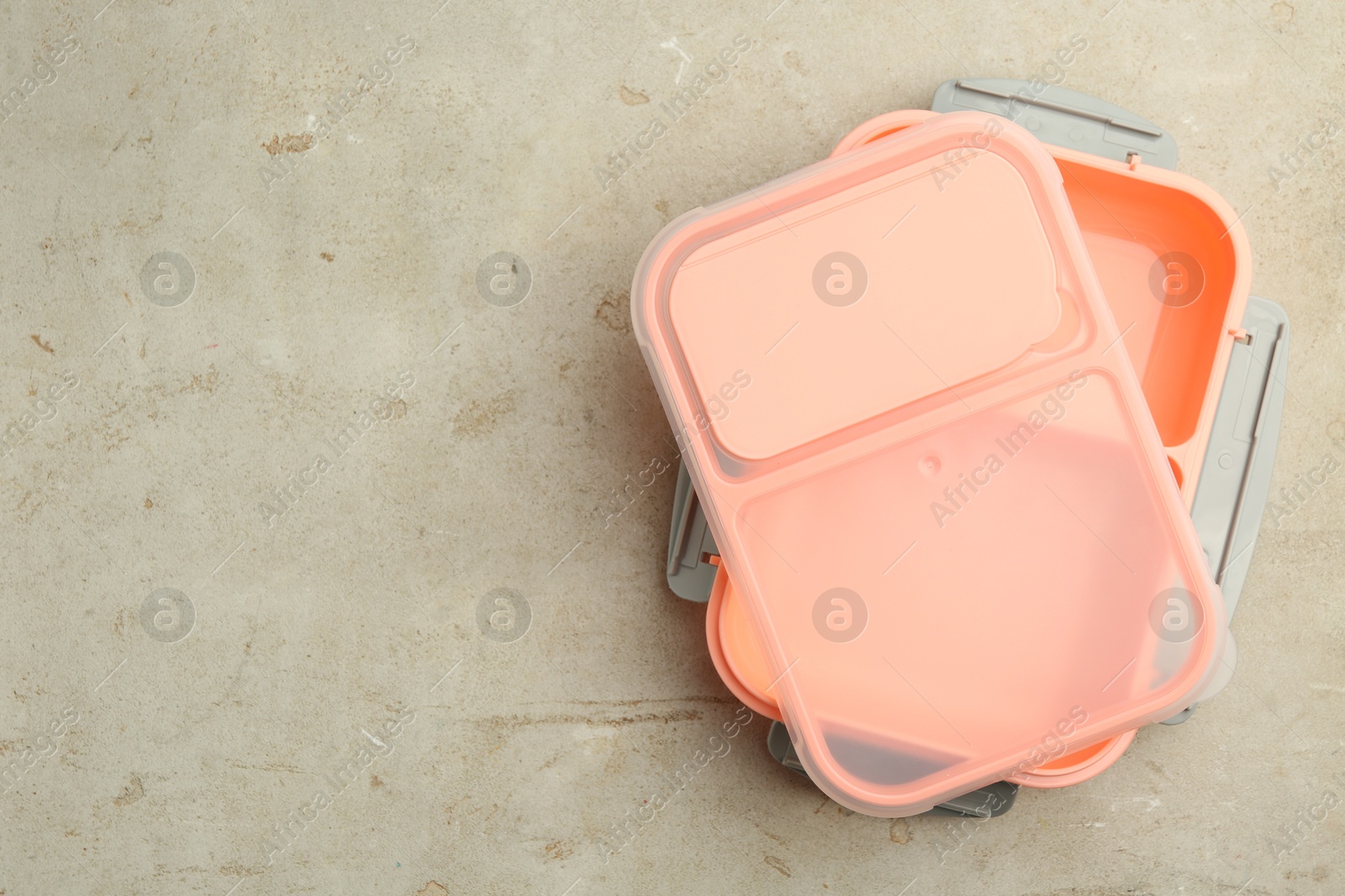 Photo of Empty plastic lunch box on grey table, top view. Space for text