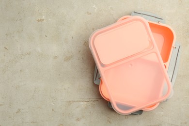 Photo of Empty plastic lunch box on grey table, top view. Space for text