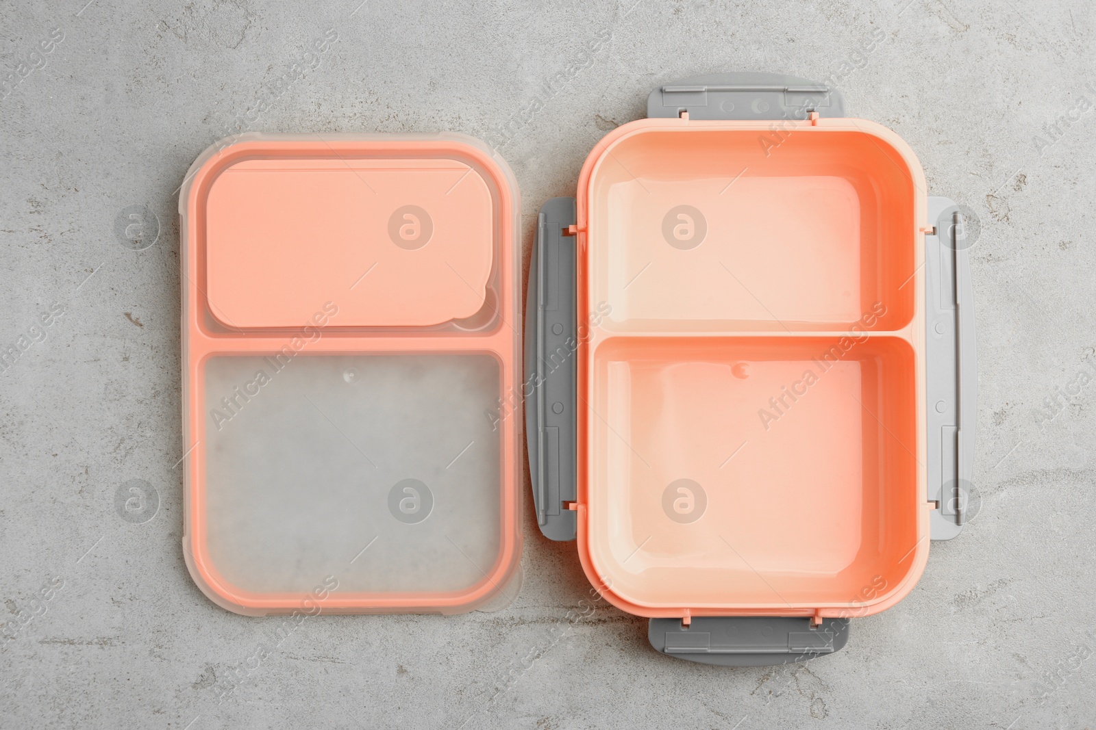 Photo of Empty plastic lunch box on grey table, top view