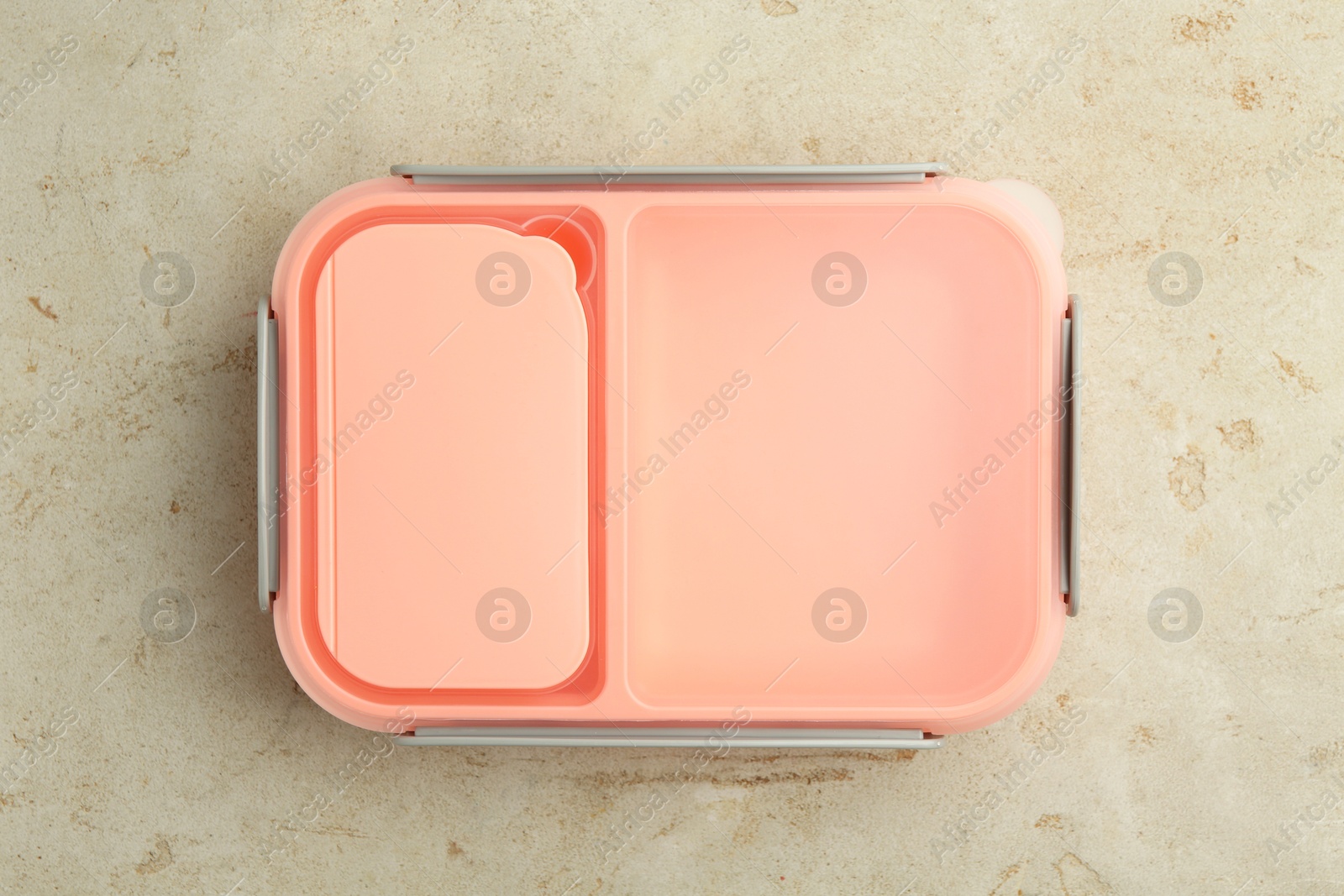 Photo of One plastic lunch box on grey table, top view