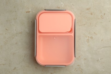 Photo of One plastic lunch box on grey table, top view