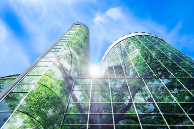 Image of Environment preservation. Double exposure of modern building and tree against blue sky, low angle view