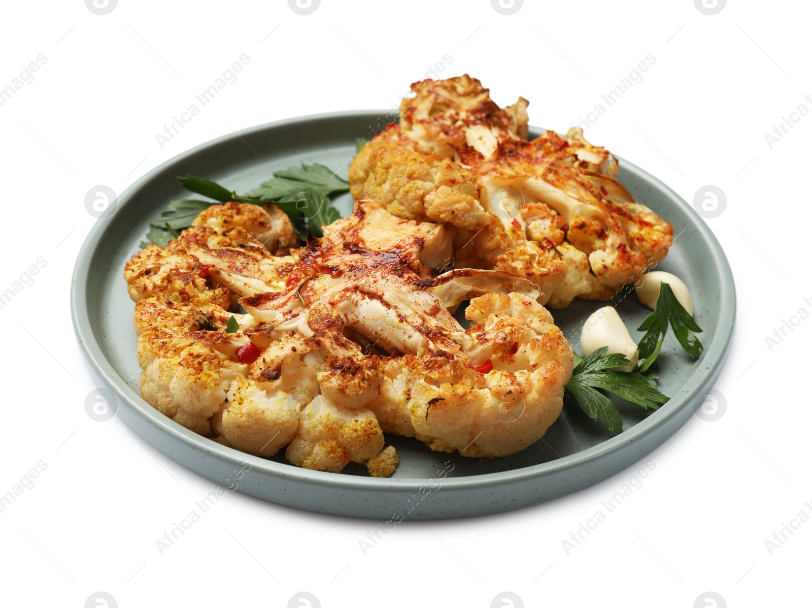 Photo of Delicious baked cauliflower steaks with garlic and parsley isolated on white