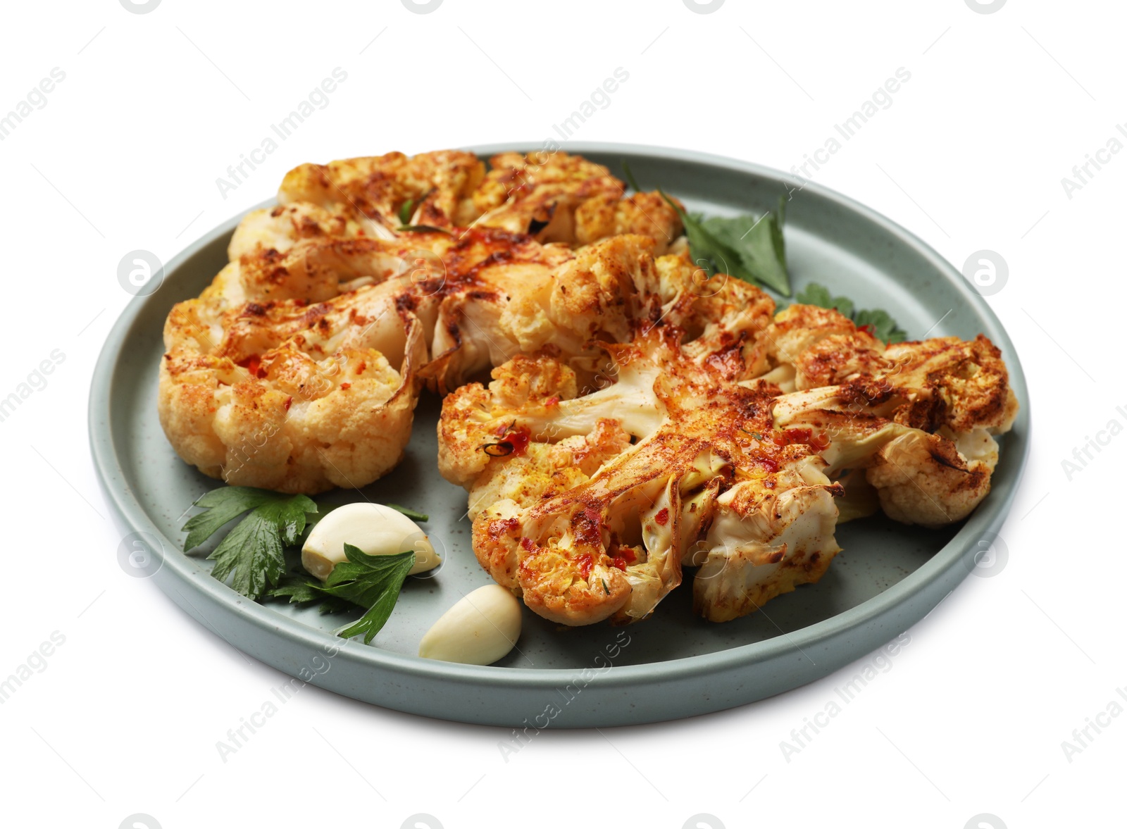 Photo of Delicious baked cauliflower steaks with garlic and parsley isolated on white