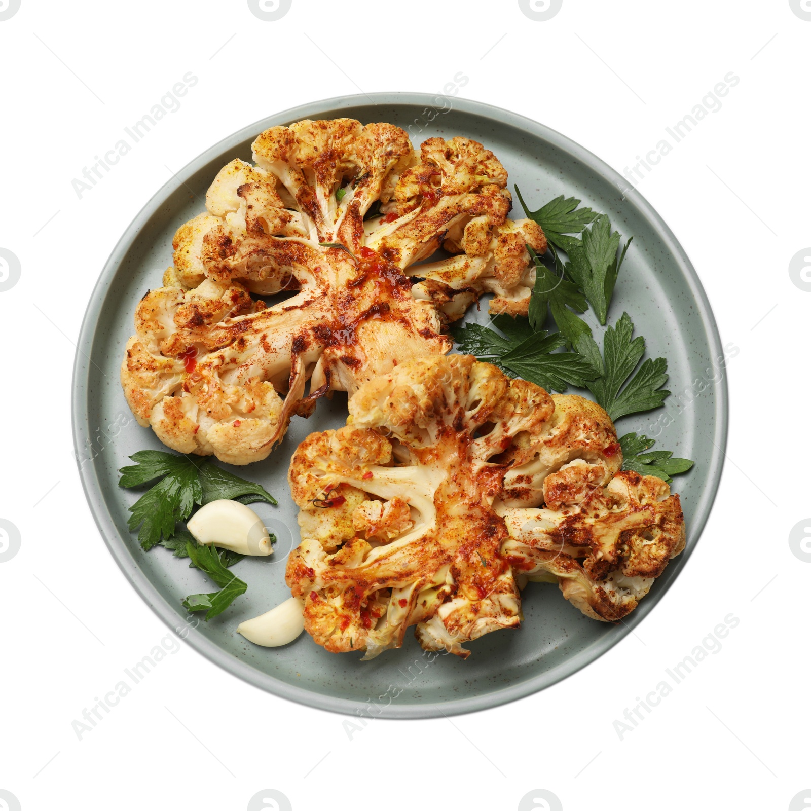 Photo of Delicious baked cauliflower steaks with garlic and parsley isolated on white, top view