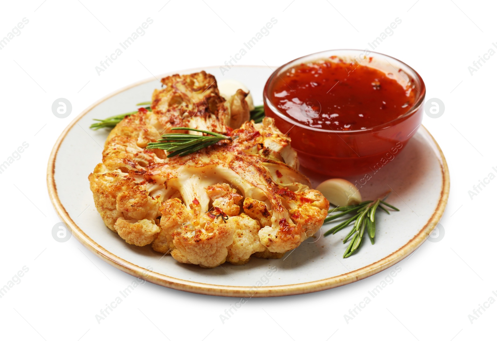 Photo of Delicious baked cauliflower steaks with sauce, garlic and rosemary isolated on white