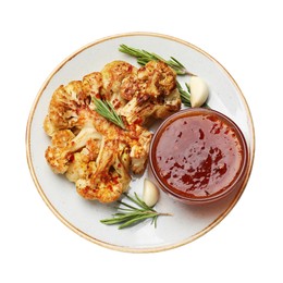 Photo of Delicious baked cauliflower steaks with sauce, garlic and rosemary isolated on white, top view