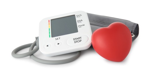 Blood pressure monitor and red decorative heart isolated on white